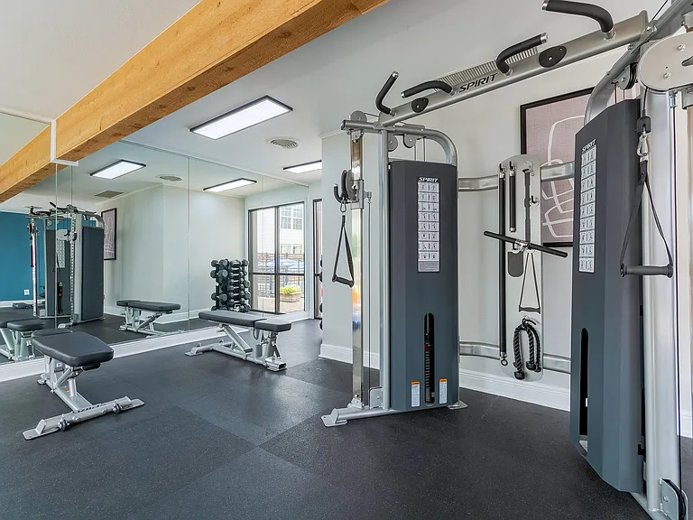 Free weights and a multi-purpose weight machine is shown in the fitness center at ReNew on Cantrell.