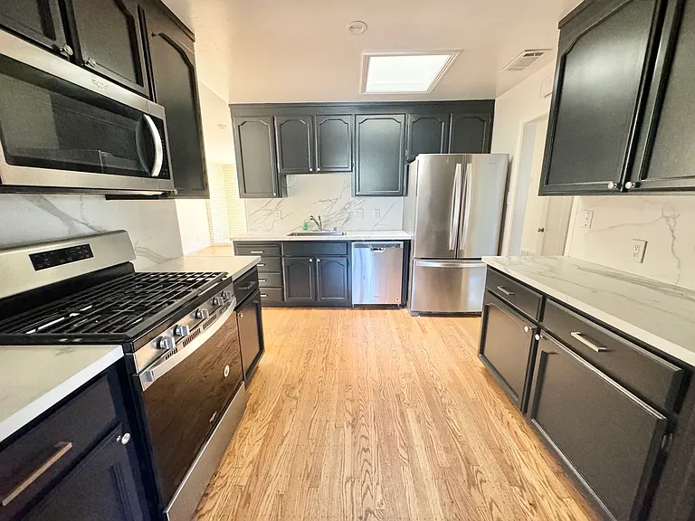 Updated kitchen with new appliances, marble countertops