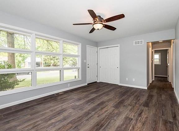 Living Room with lots of windows and GREAT natural light, a large coat closet, and ceiling fan. Designer flooring throughout the main level.