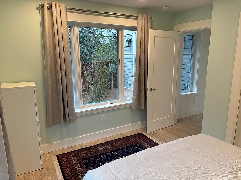 Main floor bedroom. Window overlooks private yard. Bathroom is right around the corner in the small hallway.