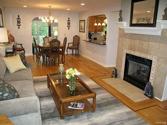 HARDWOOD flooring with contrasting MAHOGANY INLAY showcases the LIVING ROOM and DINING ROOM.