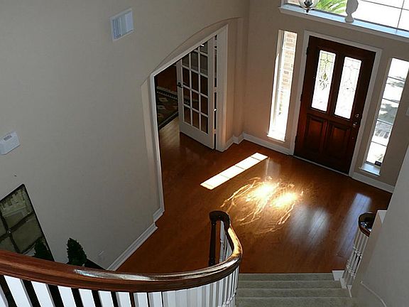 Elegant entry with spiral staircase and wood floors throughout downstairs!
