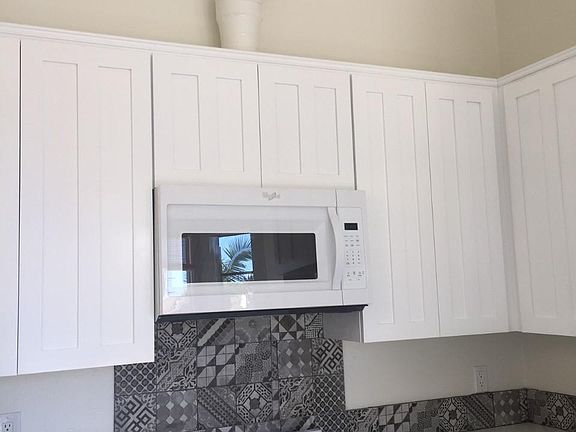 Newer kitchen with quartz counter tops and recessed lighting