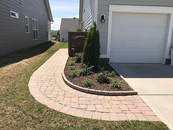Brick walkway by garbage can