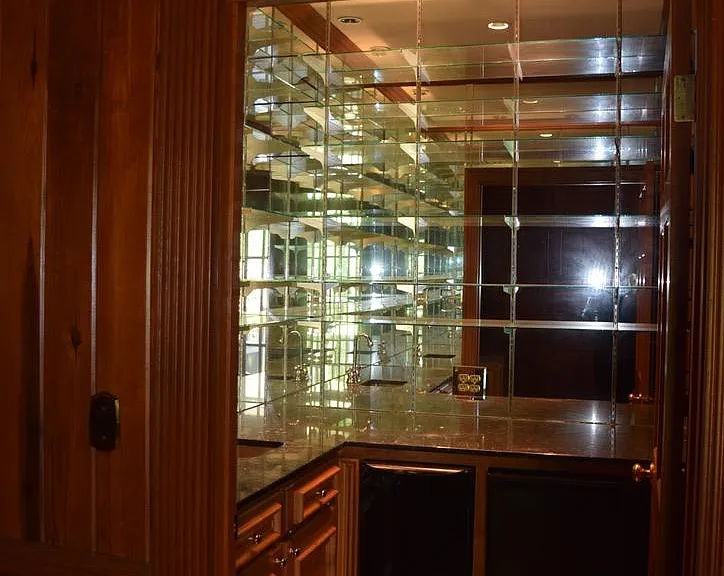 Wet Bar can be closed or left open- Opens into den. granite counter tops, stainless sink. glass shelves 
lots of storage