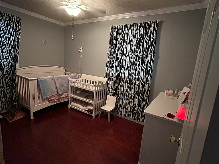 The 2nd bedroom located at the front of the house, at the end of the hallway that originates front the from living space.