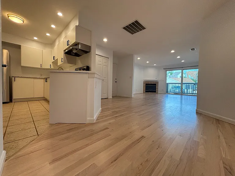 view of remodeled kitchen, entry way, and open living space