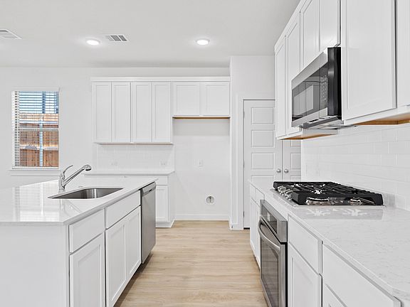 Kitchen in the Oak home plan by Trophy Signature Homes - REPRESENTATIVE PHOTO