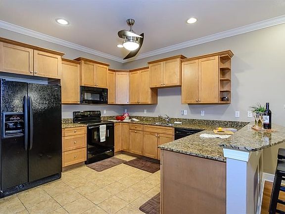 Kitchen (13.3' x 14.8') Offers Granite Adorned Custom Wood Cabinetry!
