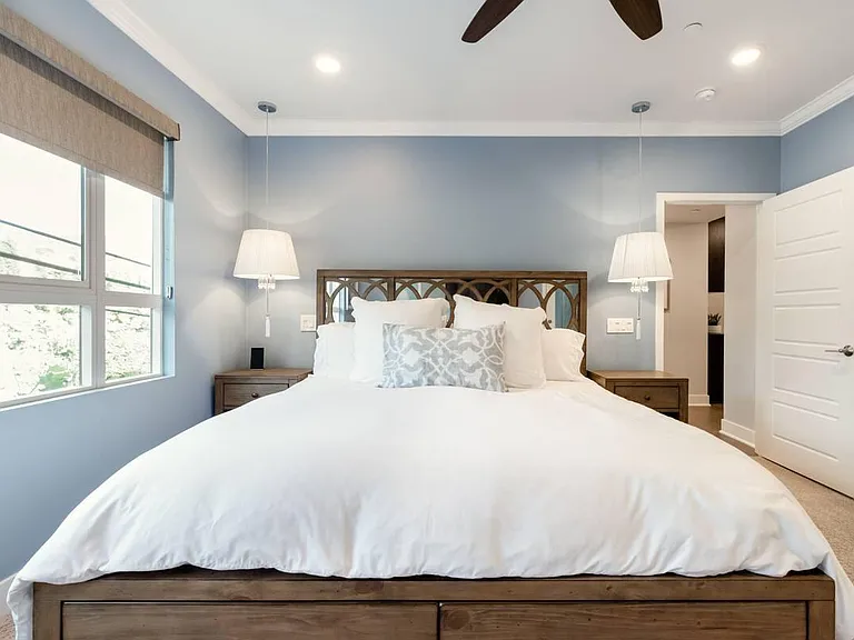Ultra soft and luxury hotel style bedding in every bedroom. This is the king sized master bedroom. One of the most comfortable bedrooms you will ever sleep in. Hanging crystal chandelier bedlamps are featured.