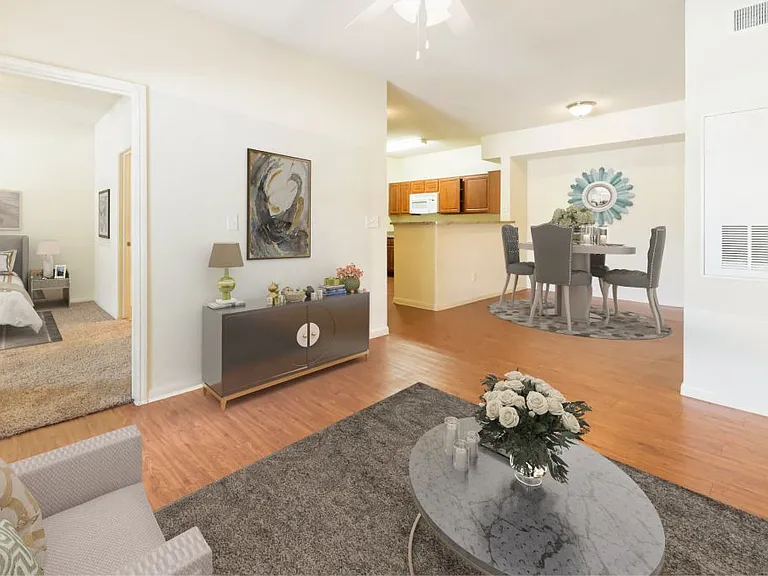 Spacious living room with wood-like plank flooring at Stonehaven Apartments in Houston, TX
