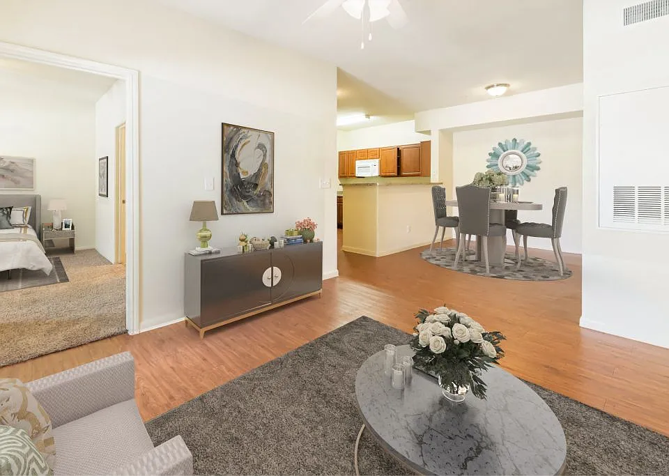 Spacious living room with wood-like plank flooring at Stonehaven Apartments in Houston, TX