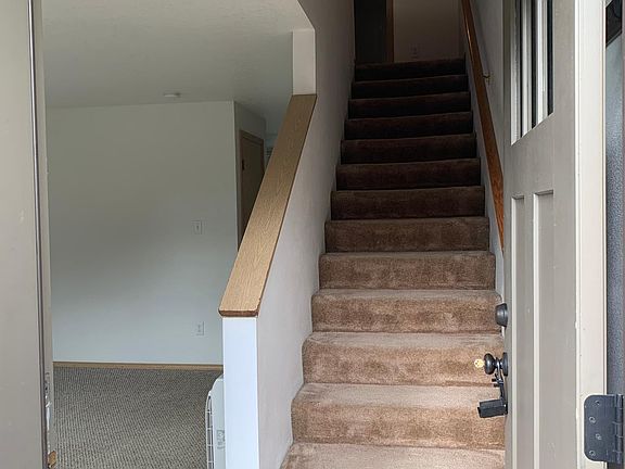 standing in the entry and seeing living room and stairs