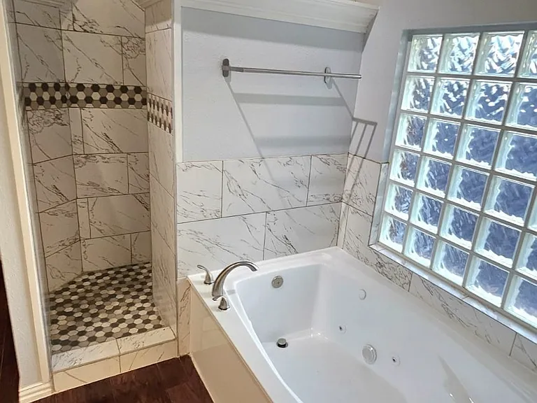 Master bathroom with jacuzzi and dual sinks