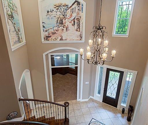 Exquisite features throughout showcase this grand entry; high ceiling, recessed lighting, crown molding, breathtaking Mediterranean murals, and over-sized tiles.