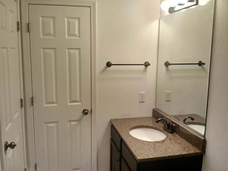 The guest bath has a large linen closet, and features a mode