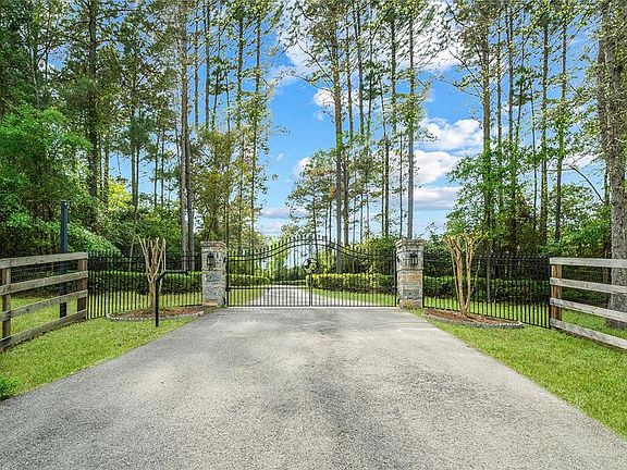 A gated double entry opens to a long drive and leads you to the beautiful home and property.