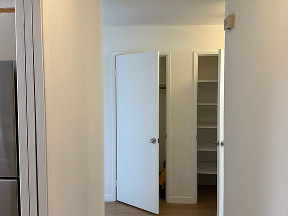 unit entrance, left to kitchen, straight left to sitting room and right to bedrooms; coat and liner closets in hallway