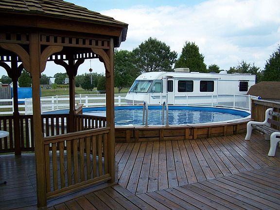 Gazebo, deck, 27' rd above grd pool, 12' x 40' pad w/30 amp for RV or boa
