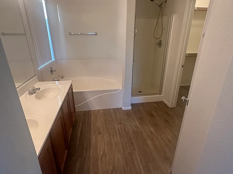 Master bathroom, with double sinks separate shower and bath tub, plus a walk-in closet.