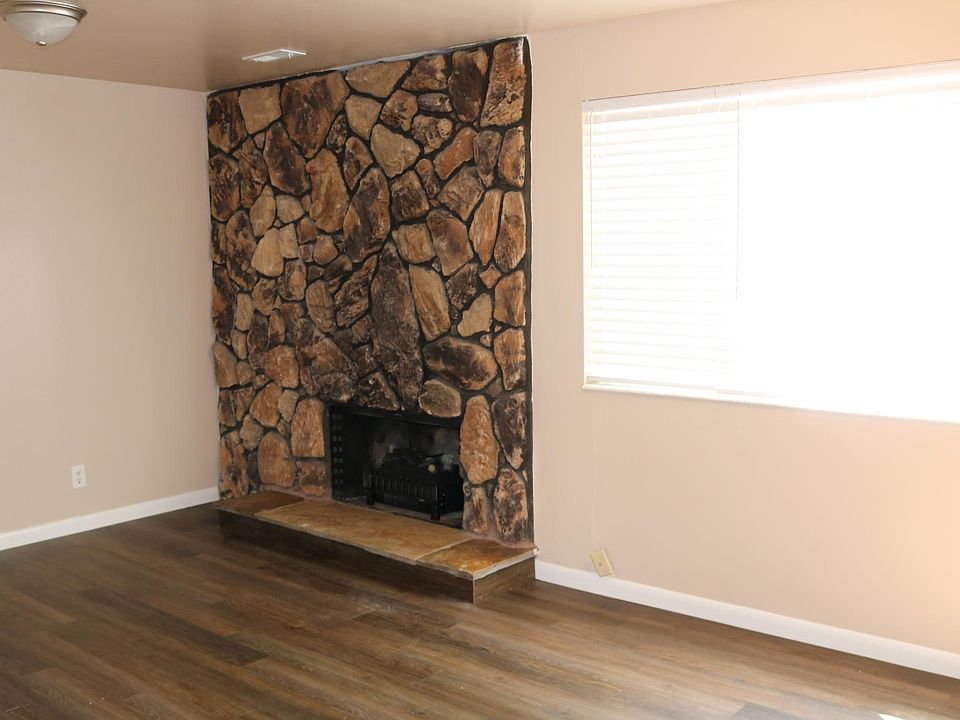 Large living room with fireplace and electric log
