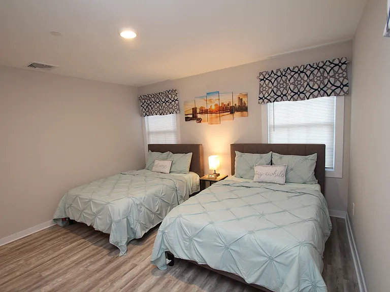 Large master's bedroom with two full beds _ ideal for families or guests.
