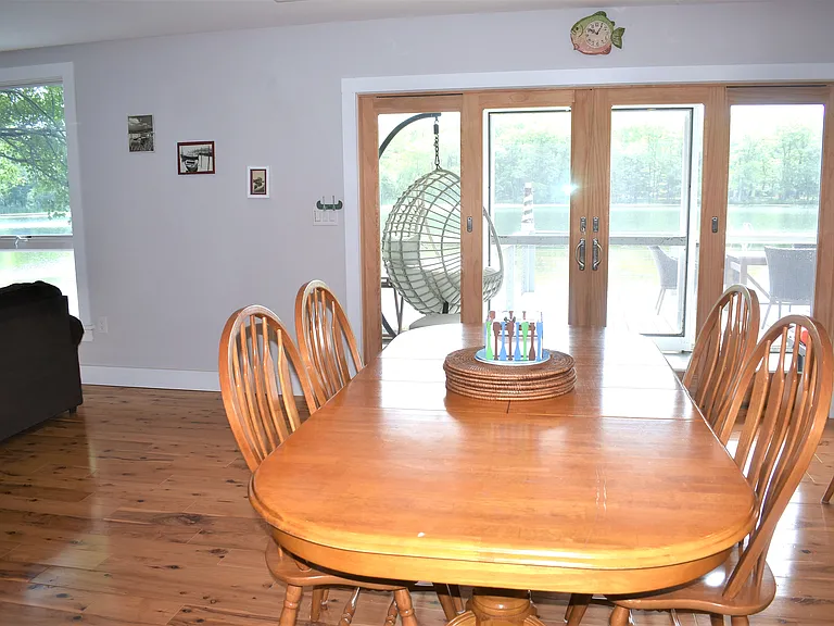 Dining area and doors to the screen porch and deck to the lake