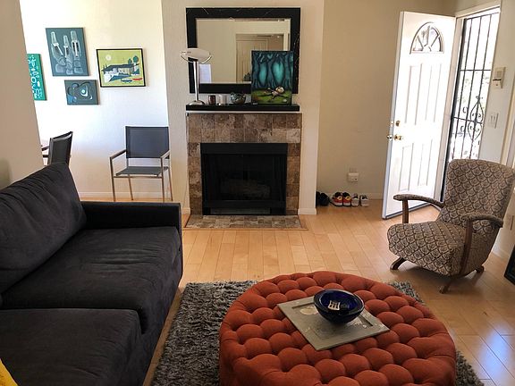 Living room with front door, fireplace.