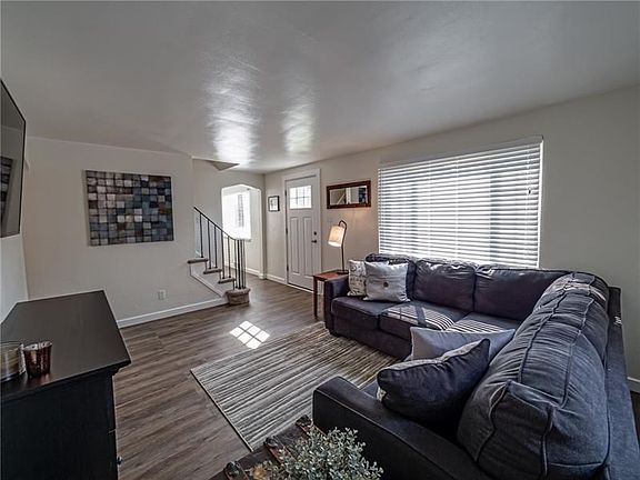Enter the spacious and bright family room featuring newer modern flooring and neutral decor.