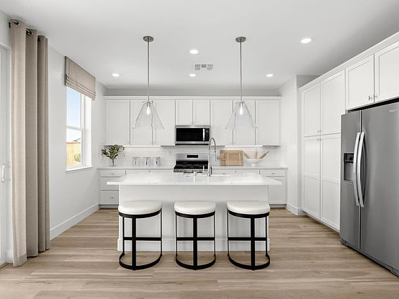 Kitchen with large central island and ample cabinetry
