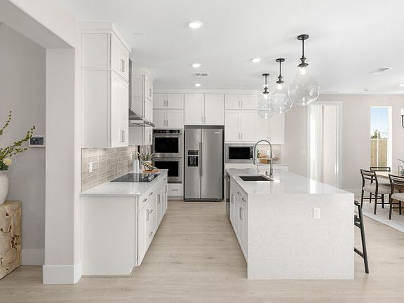 Kitchen with large central island and open to main dining area