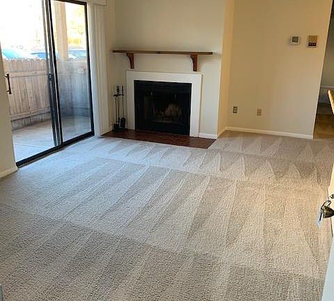 Walking into 2275 A- wood buring fireplace