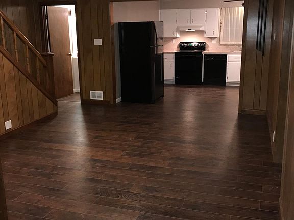 Family room looking into the dining room and kitchen. Bathroom is at the bottom of the steps. Giant sized rooms!