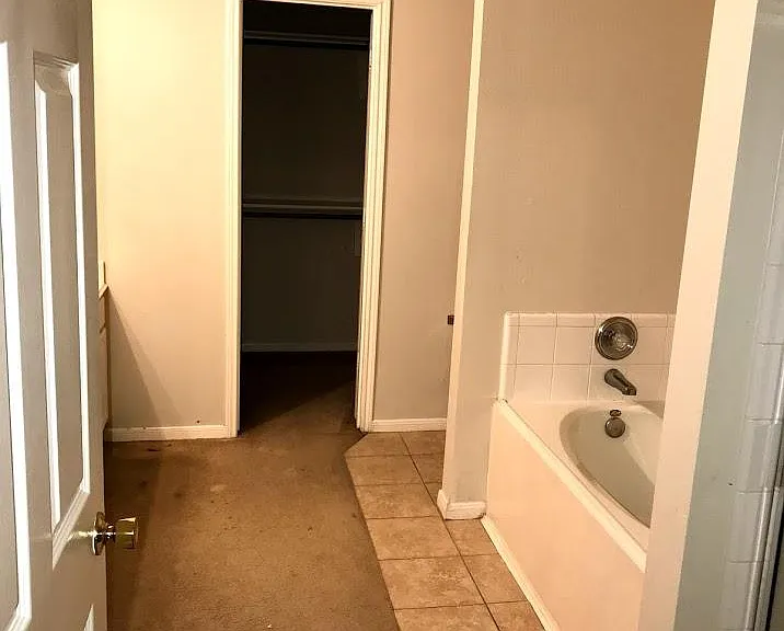 Master bathroom view from bedroom looking into the closet