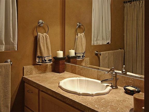Travertine bathrooms with brushed nickel.