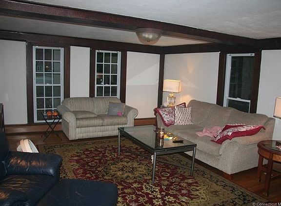 Exposed beam living room wi...