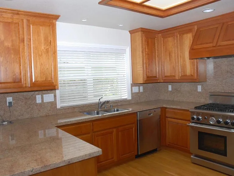 Kitchen-Designer culinary space including a motion-activated fixture from Moen, eco-friendly LED illumination and granite finish.