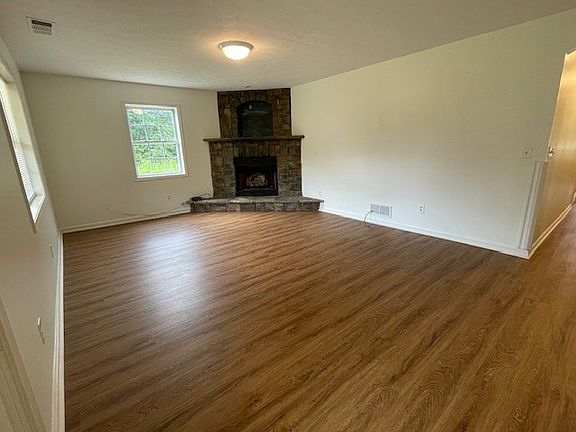 Den with stacked stone fireplace