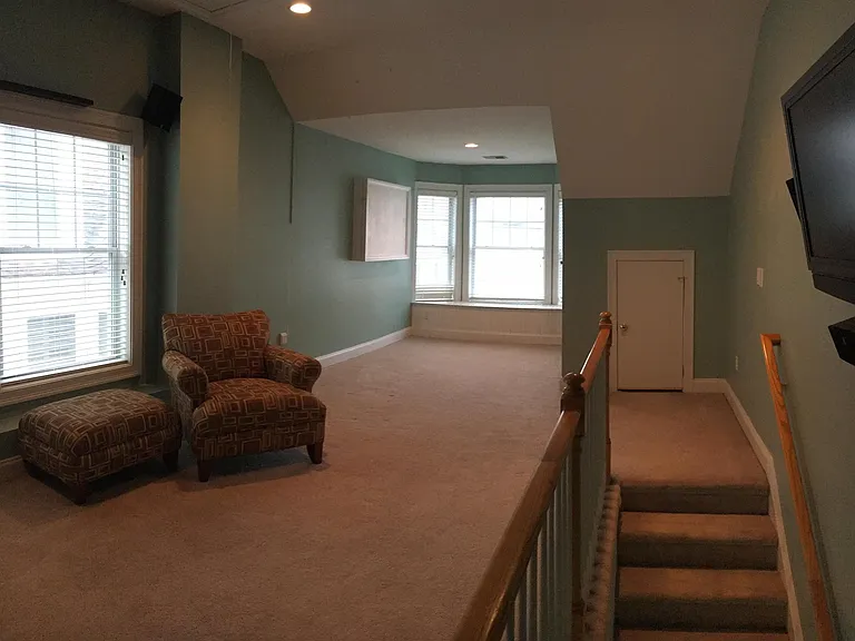 Spacious third floor loft space (chair not included) great as a bonus living room, office or extra bedroom. Storage closet and pull down attic.