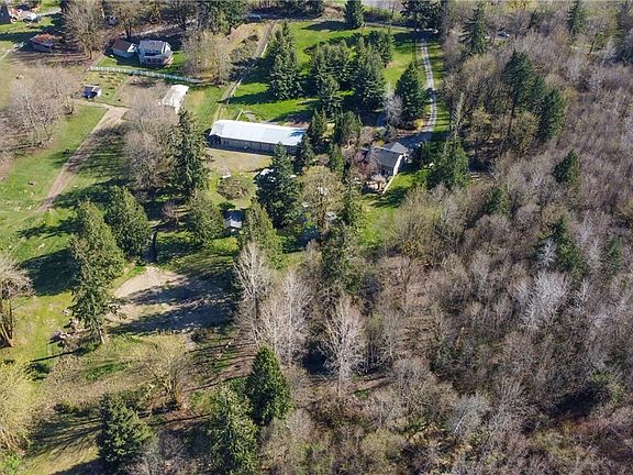 10+ acres, 2 driveways for easy access to shop/barn, arena space, private ponds, cabin and chicken coop/loafing shed.  A dream come true!