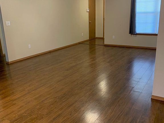 Photo from kitchen wall back to garage entry door, coat closet on left wall, and entry door on right not seen