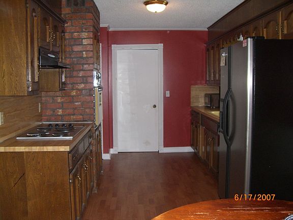 New cooktop and laminate wood flooring have been added to this large kitchen