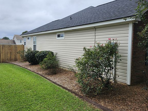 Close-up view of the left side of the property. See rear back view to enter the backyard through the fence.