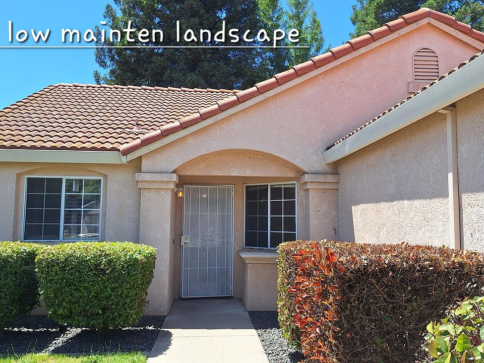 Beautiful stucco Spanish-style home with drought-resistant landscape.