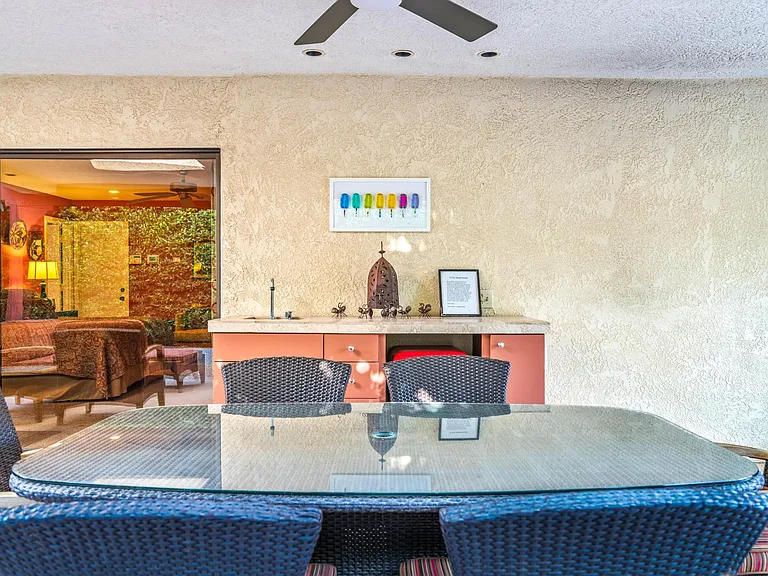 Outdoor dining table near outdoor wet bar.