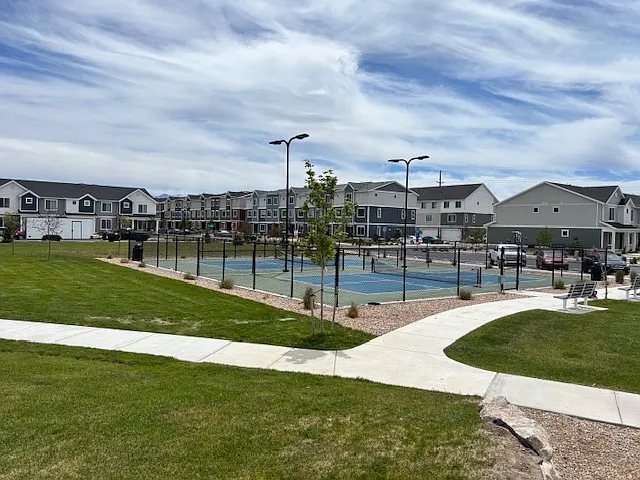 Pickleball courts next to pool in front of house