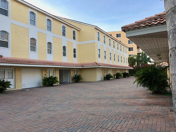 View of unit from front with garage door open.