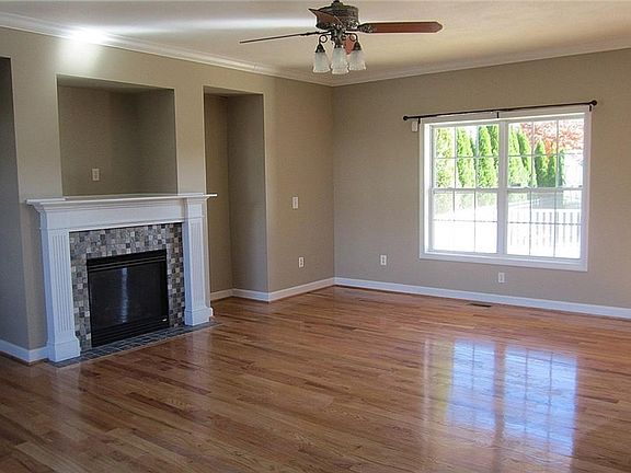 Front-to-back Greatroom - Freshly painted, gleaming real hardwood floors, and gas fireplace w/tiled hearth