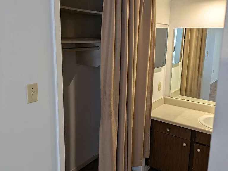 Large closet alongside the vanity. Some closets in oour units have curtains like this one; others have bifold doors.