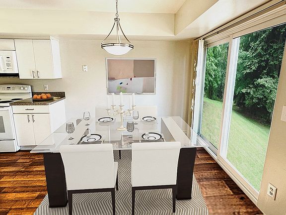 Modern white appliances and cabinetry in large well-designed kitchen